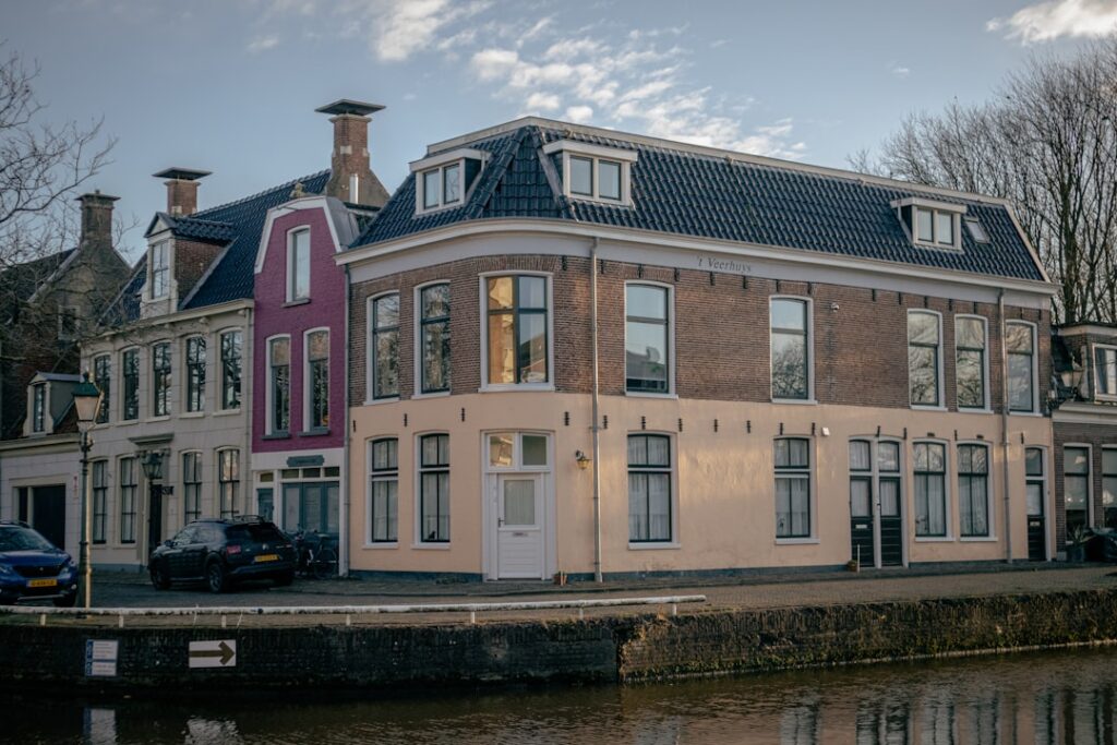 a large brick building next to a body of water