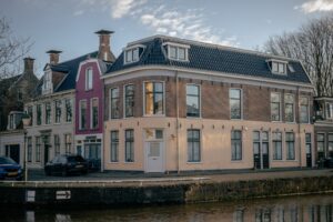 a large brick building next to a body of water